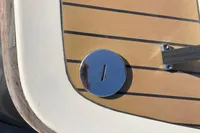 Close-up of GS 27 boat deck, featuring wood finish and metal fixture, 2022 model.