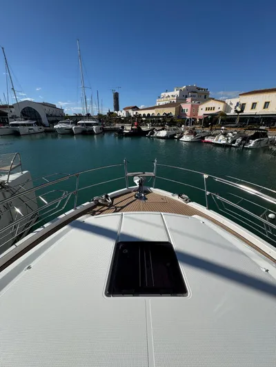 Lady V Yacht Photos Pics 2024 Bavaria Virtess 420 Fly yacht docked in a scenic marina.