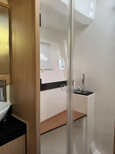 Lady V Yacht Photos Pics 2024 Bavaria Virtess 420 Fly yacht bathroom with modern wood and glass design.