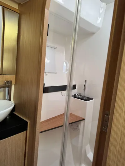 Lady V Yacht Photos Pics 2024 Bavaria Virtess 420 Fly yacht bathroom with modern fixtures and wooden accents.