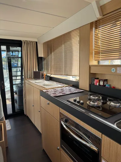 Lady V Yacht Photos Pics 2024 Bavaria Virtess 420 Fly yacht kitchen with modern appliances and sleek wooden cabinetry.