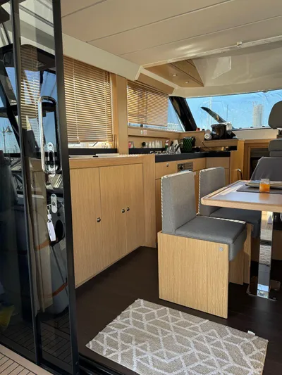 Lady V Yacht Photos Pics 2024 Bavaria Virtess 420 Fly yacht interior with modern dining area and wooden cabinetry.