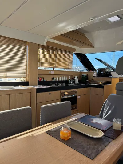Lady V Yacht Photos Pics Luxurious interior of 2024 Bavaria Virtess 420 Fly yacht with modern kitchen and dining area.