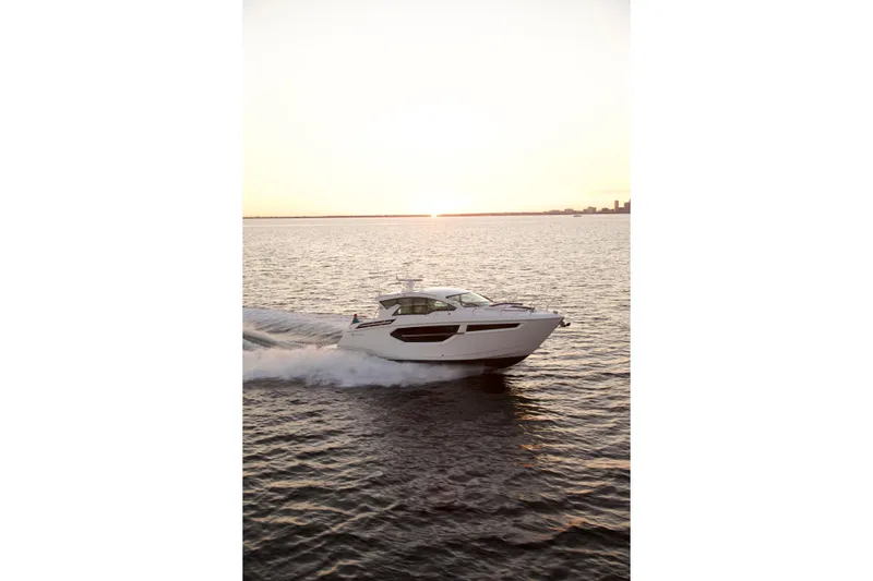  Yacht Photos Pics 2026 Cruisers Yachts 42 Cantius cruising at sunset on open water.