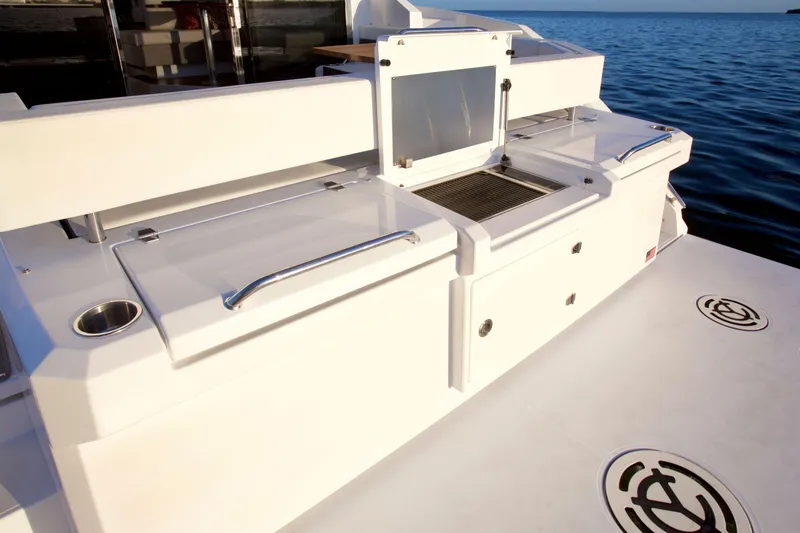  Yacht Photos Pics 2026 Cruisers Yachts 42 Cantius deck with sleek white design and ocean backdrop.