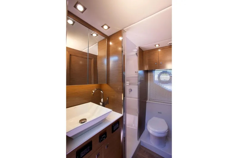  Yacht Photos Pics Luxurious bathroom in 2026 Cruisers Yachts 42 Cantius, featuring modern fixtures and elegant wood finishes.