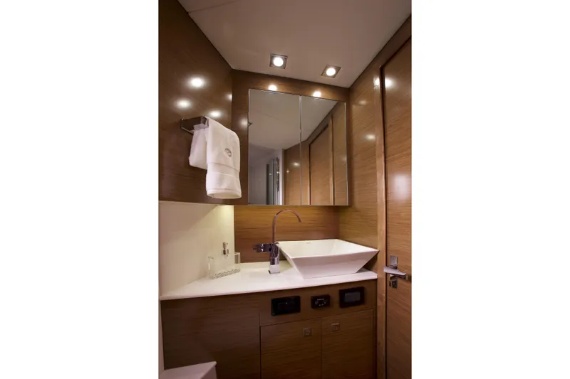  Yacht Photos Pics Luxurious bathroom in 2026 Cruisers Yachts 42 Cantius, featuring modern sink and elegant wood finishes.