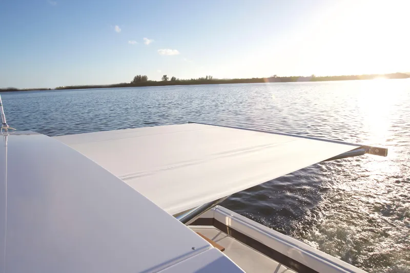  Yacht Photos Pics 2026 Cruisers Yachts 42 Cantius on serene water at sunset.