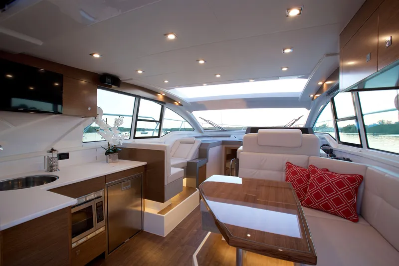 Yacht Photos Pics Luxurious interior of 2026 Cruisers Yachts 42 Cantius with modern kitchen and seating area.