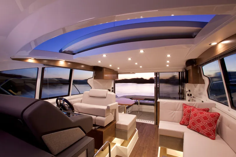  Yacht Photos Pics Luxurious interior of 2026 Cruisers Yachts 42 Cantius with modern seating and panoramic windows.
