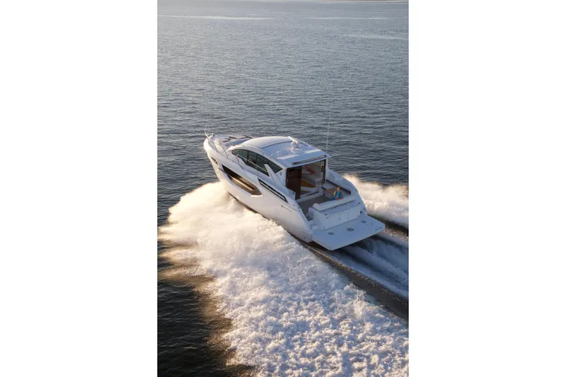  Yacht Photos Pics 2026 Cruisers Yachts 42 Cantius cruising on open water, rear view.