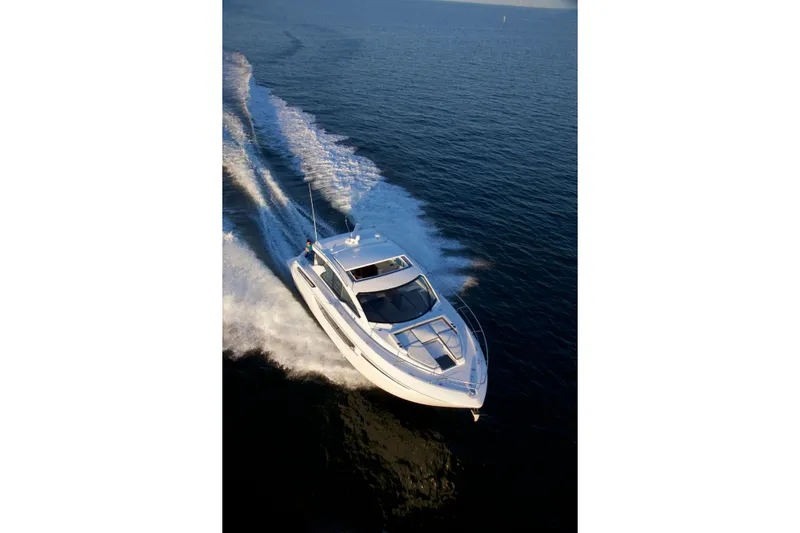  Yacht Photos Pics 2026 Cruisers Yachts 42 Cantius cruising on open water, aerial view.