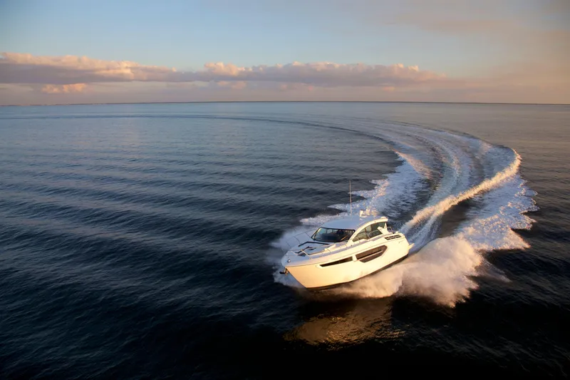  Yacht Photos Pics 2026 Cruisers Yachts 42 Cantius cruising on open water at sunset.