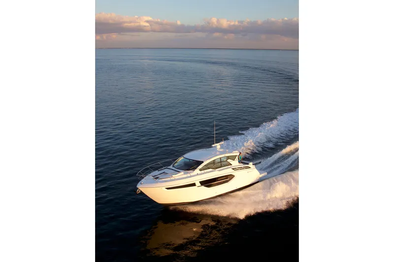  Yacht Photos Pics 2026 Cruisers Yachts 42 Cantius cruising on open water at sunset.