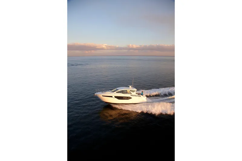  Yacht Photos Pics 2026 Cruisers Yachts 42 Cantius cruising on open water at sunset.