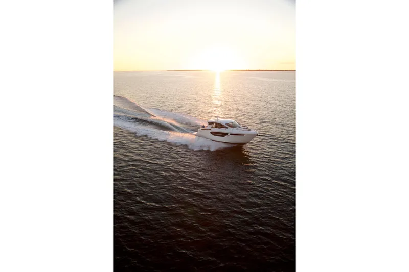  Yacht Photos Pics 2026 Cruisers Yachts 42 Cantius cruising at sunset on open water.