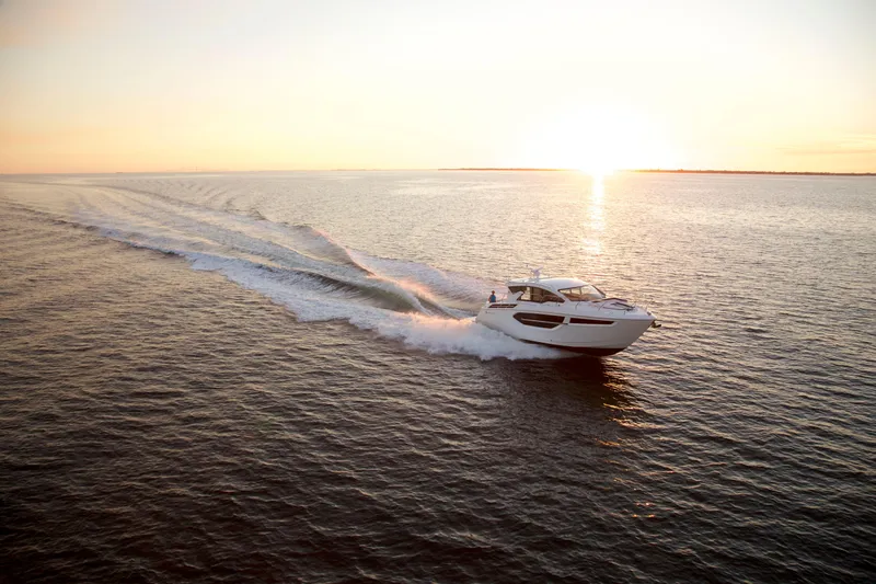  Yacht Photos Pics 2026 Cruisers Yachts 42 Cantius cruising at sunset on open water.