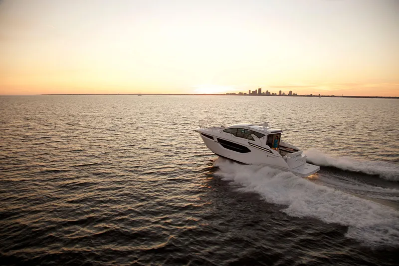  Yacht Photos Pics 2026 Cruisers Yachts 42 Cantius cruising at sunset on open water.