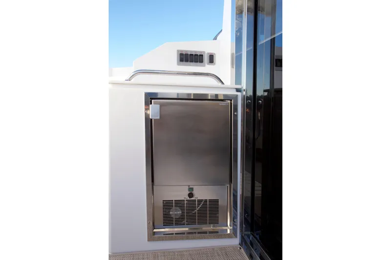  Yacht Photos Pics Stainless steel appliance on 2026 Cruisers Yachts 42 Cantius deck, under clear blue sky.