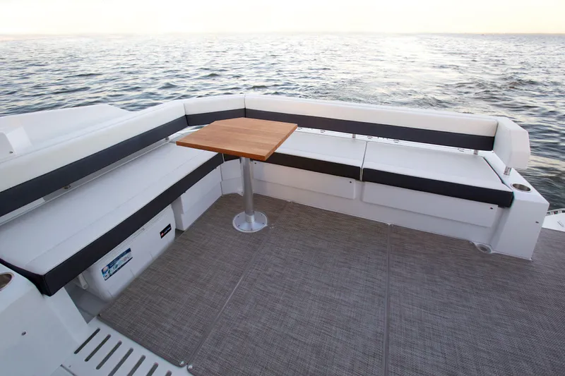  Yacht Photos Pics 2026 Cruisers Yachts 42 Cantius deck with seating and table, overlooking the ocean.