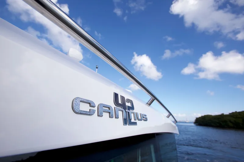 Yacht Photos Pics 2026 Cruisers Yachts 42 Cantius on water, clear sky background.