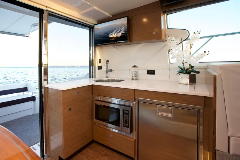  Yacht Photos Pics Luxurious interior of 2026 Cruisers Yachts 42 Cantius with modern kitchen amenities.