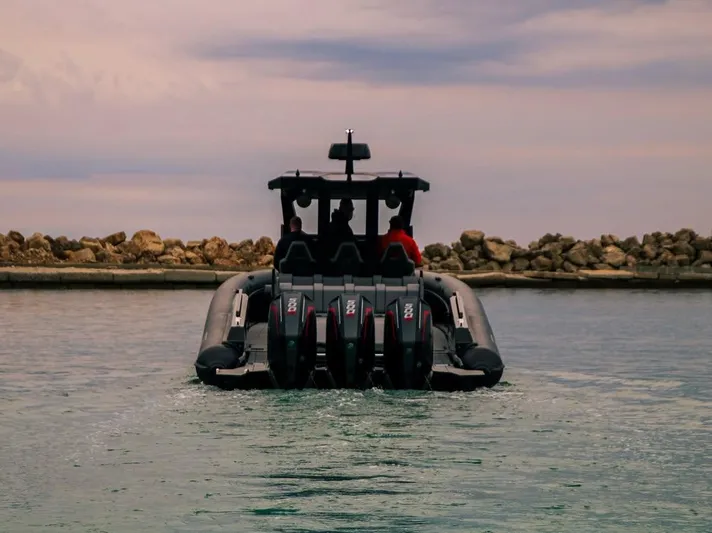 Skipper 42 Triple 500r Yacht Photos Pics Skipper-BSK 42 boat, 2026 model, cruising on water with rocky shoreline background.