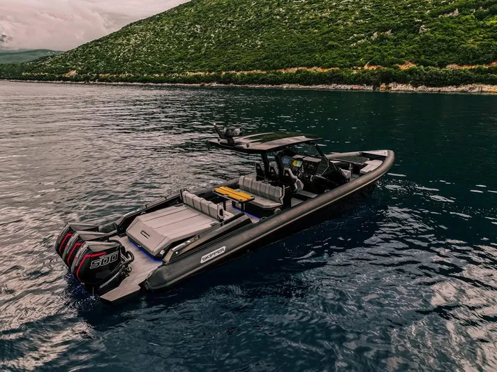 Skipper 42 Triple 500r Yacht Photos Pics Skipper-BSK 42 boat on water, 2026 model, with scenic green hillside background.