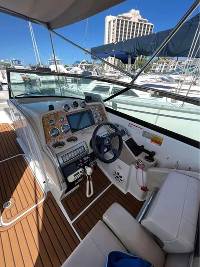  Yacht Photos Pics 2009 Formula 310 BR boat cockpit with modern controls, wood accents, and marina backdrop.