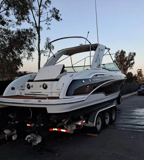  Yacht Photos Pics 2009 Formula 310 BR boat on trailer, parked outdoors at dusk.