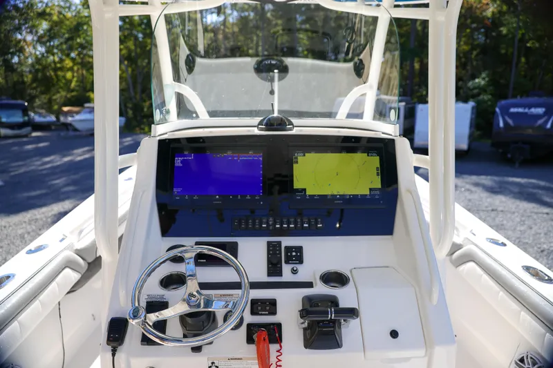  Yacht Photos Pics 2019 Regulator 28 boat dashboard with dual navigation screens and steering wheel.