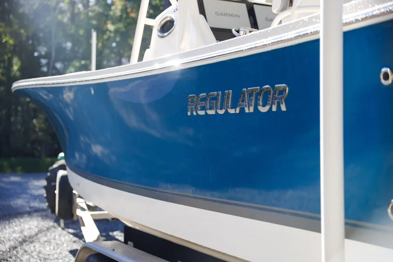  Yacht Photos Pics 2019 Regulator 28 boat with blue hull and chrome logo.