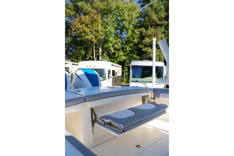  Yacht Photos Pics 2019 Regulator 28 boat interior with foldable seating, surrounded by trees and RVs.