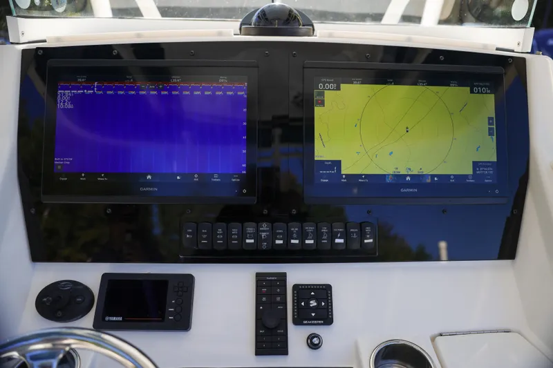  Yacht Photos Pics Control panel of a 2019 Regulator 28 boat with Garmin navigation displays.