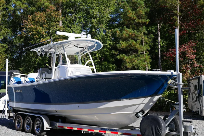 Yacht Photos Pics 2019 Regulator 28 boat on trailer, surrounded by trees.