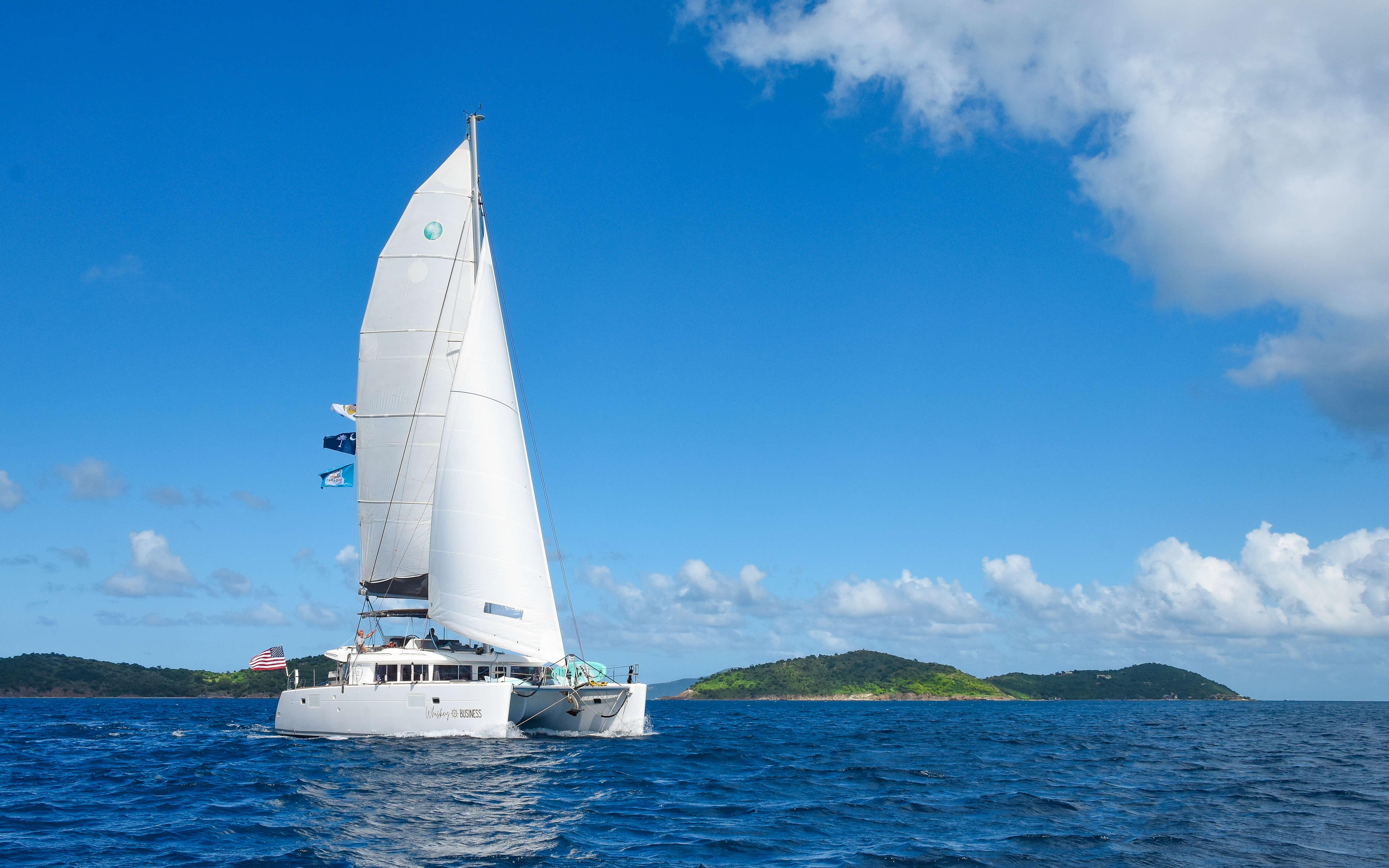 Lagoon 450F 2015 sailing near tropical islands under clear blue sky.