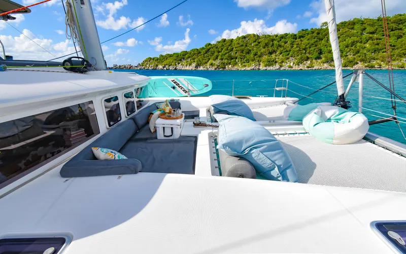 Whiskey Business Yacht Photos Pics Lagoon 450F 2015 catamaran with luxurious deck, cushions, and ocean view.