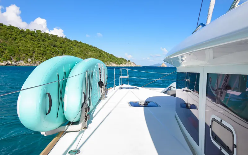 Whiskey Business Yacht Photos Pics Lagoon 450F catamaran sailing in clear blue waters, 2015 model.