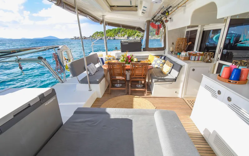 Whiskey Business Yacht Photos Pics Luxurious Lagoon 450F 2015 yacht interior with dining area, ocean view, and comfortable seating.