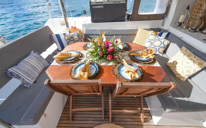 Whiskey Business Yacht Photos Pics Luxurious dining setup on 2015 Lagoon 450F yacht with elegant tableware and floral centerpiece.