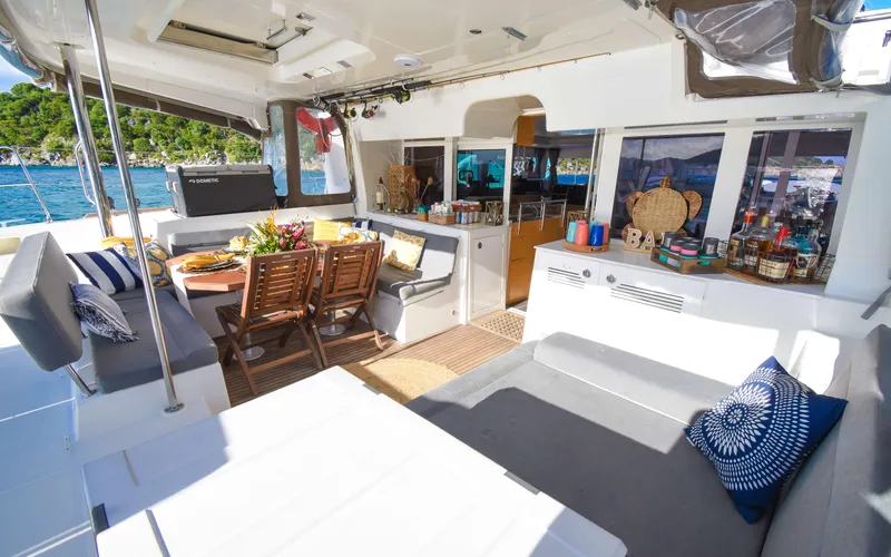 Whiskey Business Yacht Photos Pics Luxurious 2015 Lagoon 450F yacht interior with dining area and scenic ocean view.