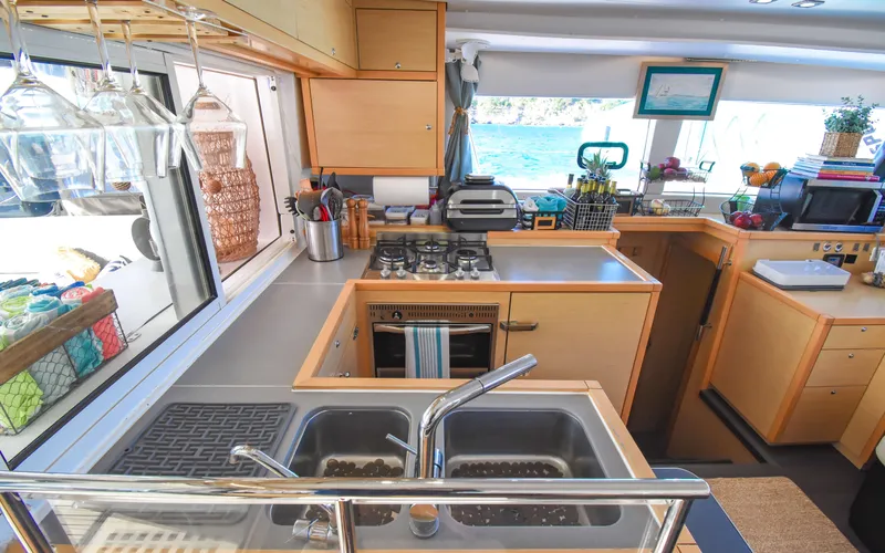 Whiskey Business Yacht Photos Pics Interior of 2015 Lagoon 450F yacht kitchen with modern amenities and ocean view.