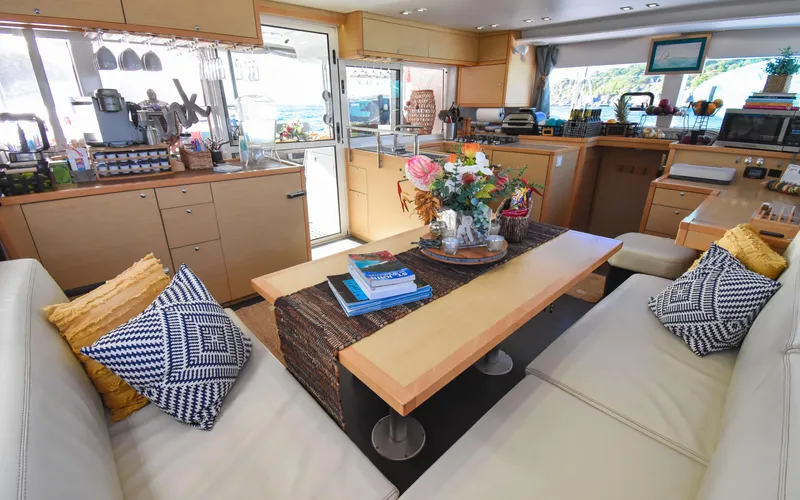 Whiskey Business Yacht Photos Pics Interior of 2015 Lagoon 450F yacht, featuring a cozy seating area and modern kitchen.