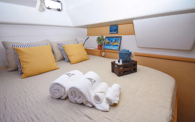 Whiskey Business Yacht Photos Pics Cozy cabin interior of 2015 Lagoon 450F with neatly arranged towels and decorative pillows.