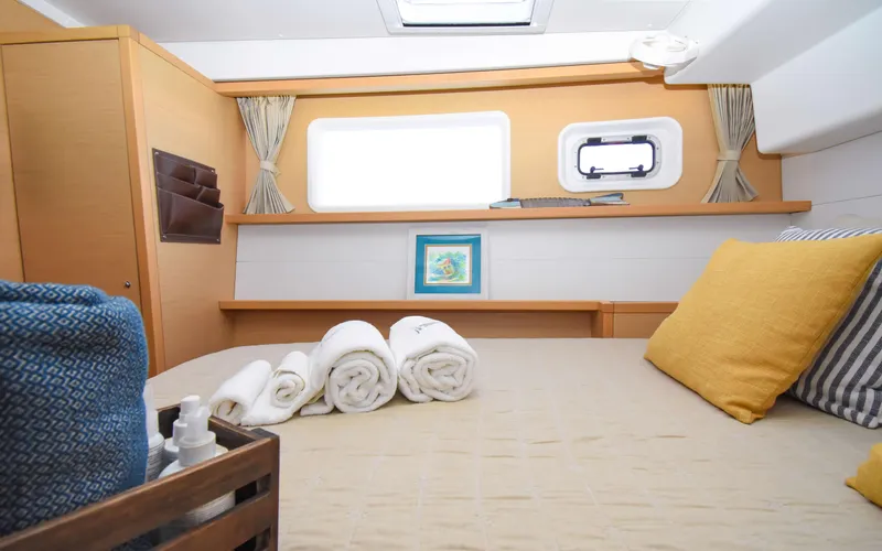 Whiskey Business Yacht Photos Pics Cozy cabin interior of 2015 Lagoon 450F yacht with neatly arranged towels and pillows.