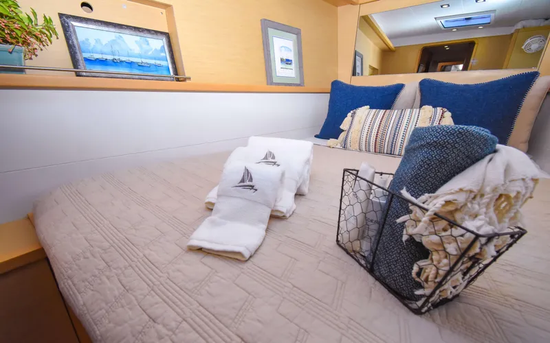 Whiskey Business Yacht Photos Pics Interior of 2015 Lagoon 450F yacht cabin with cozy bedding and decorative pillows.