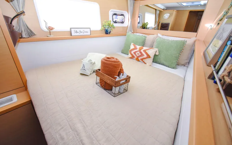 Whiskey Business Yacht Photos Pics Cozy bedroom interior of 2015 Lagoon 450F yacht with stylish decor and comfortable bedding.