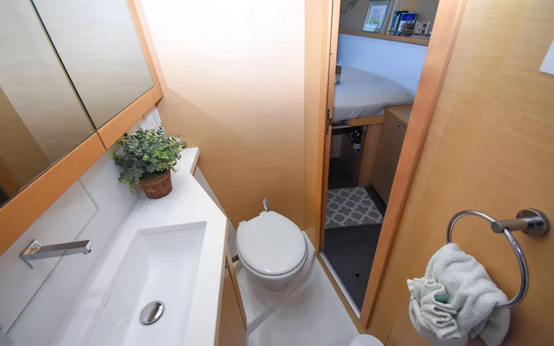 Whiskey Business Yacht Photos Pics Bathroom interior of 2015 Lagoon 450F yacht, featuring modern fixtures and cozy design.