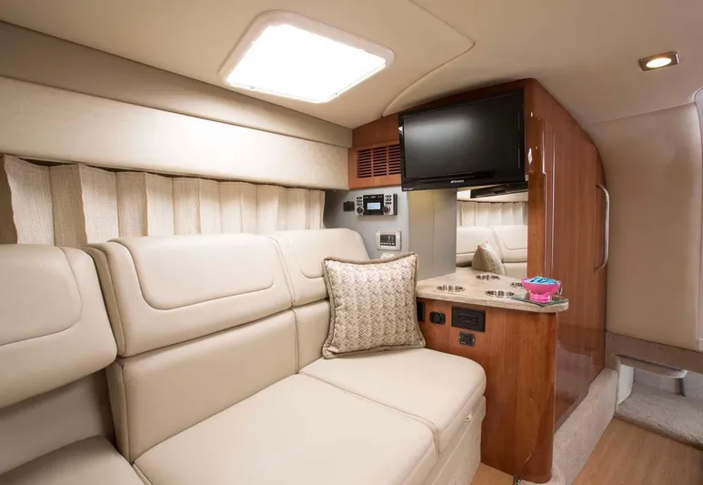 Opty Mystic Yacht Photos Pics 2018 Formula 310 Sun Sport interior with beige leather seating and mounted TV.