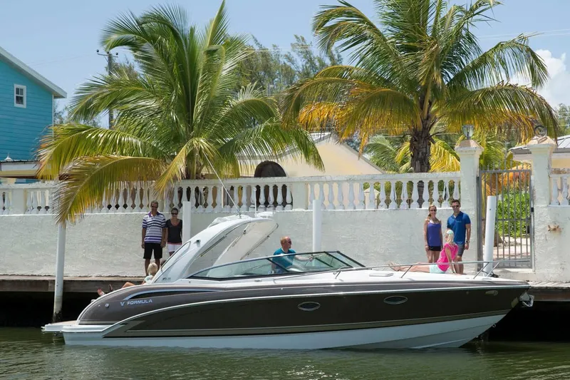 Opty Mystic Yacht Photos Pics 2018 Formula 310 Sun Sport boat docked near a tropical waterfront home.